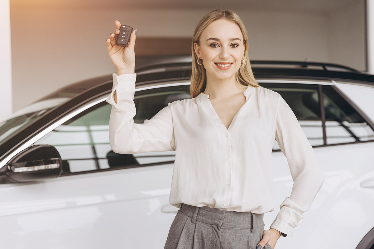 Happy owner. overjoyed caucasian blonde lady holding keys of her